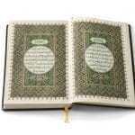 Open Koran book isolated on white background