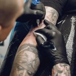 Man doing a tattoo in a tattoo salon