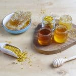 Various kinds of honey in glass jars,honeycomb and pollen.